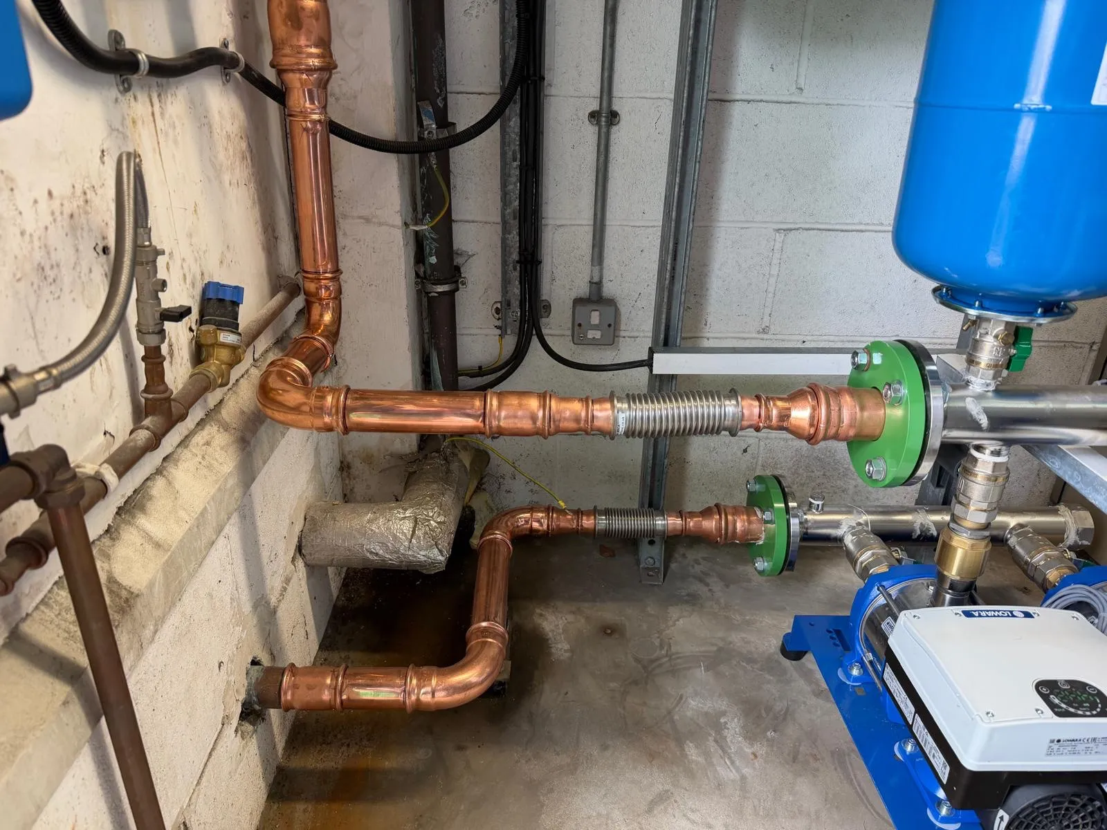 New copper supply and feed pipework run into the booster set in Grangemouth