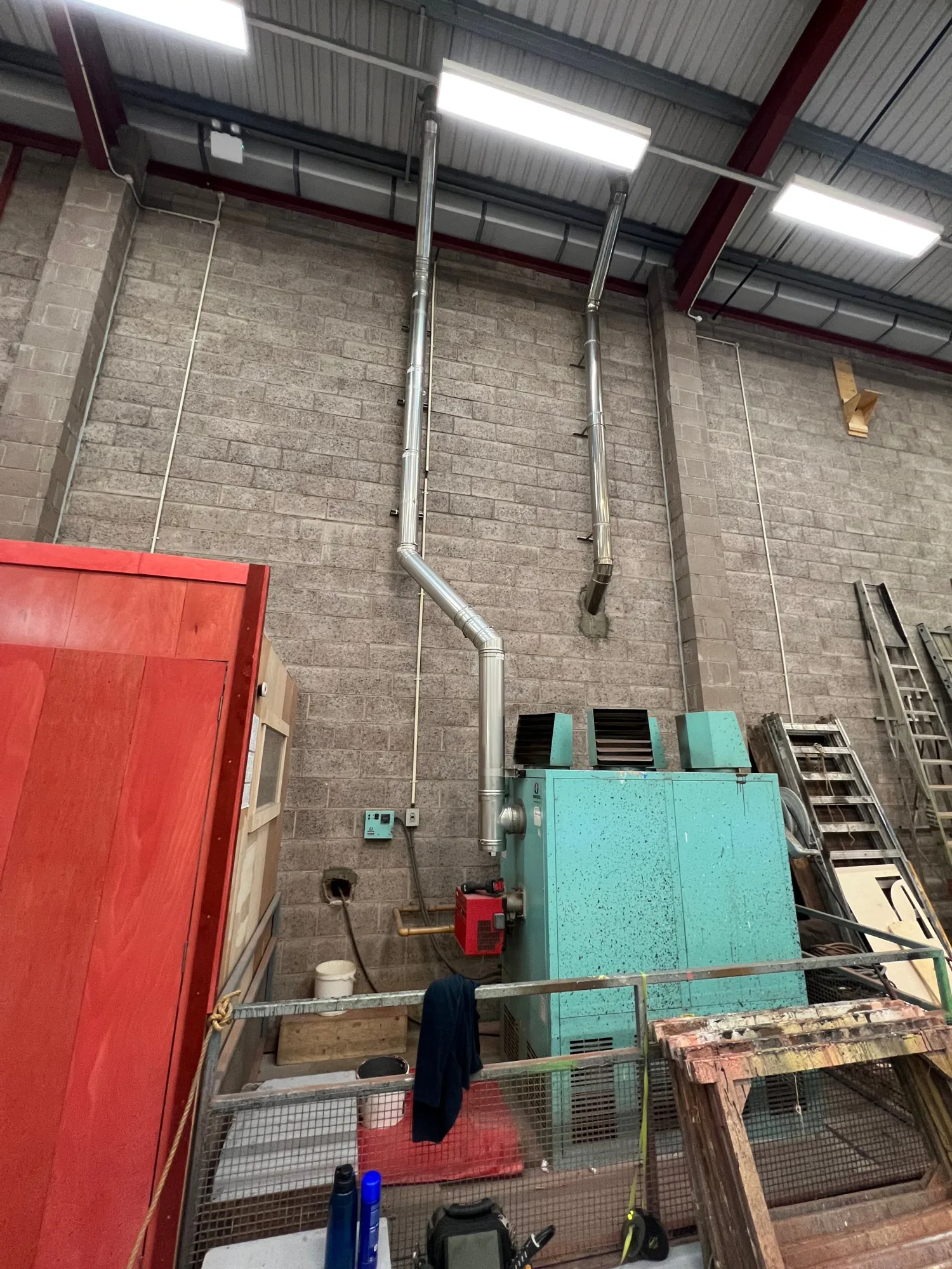 The old floor-standing warm air heater being replaced