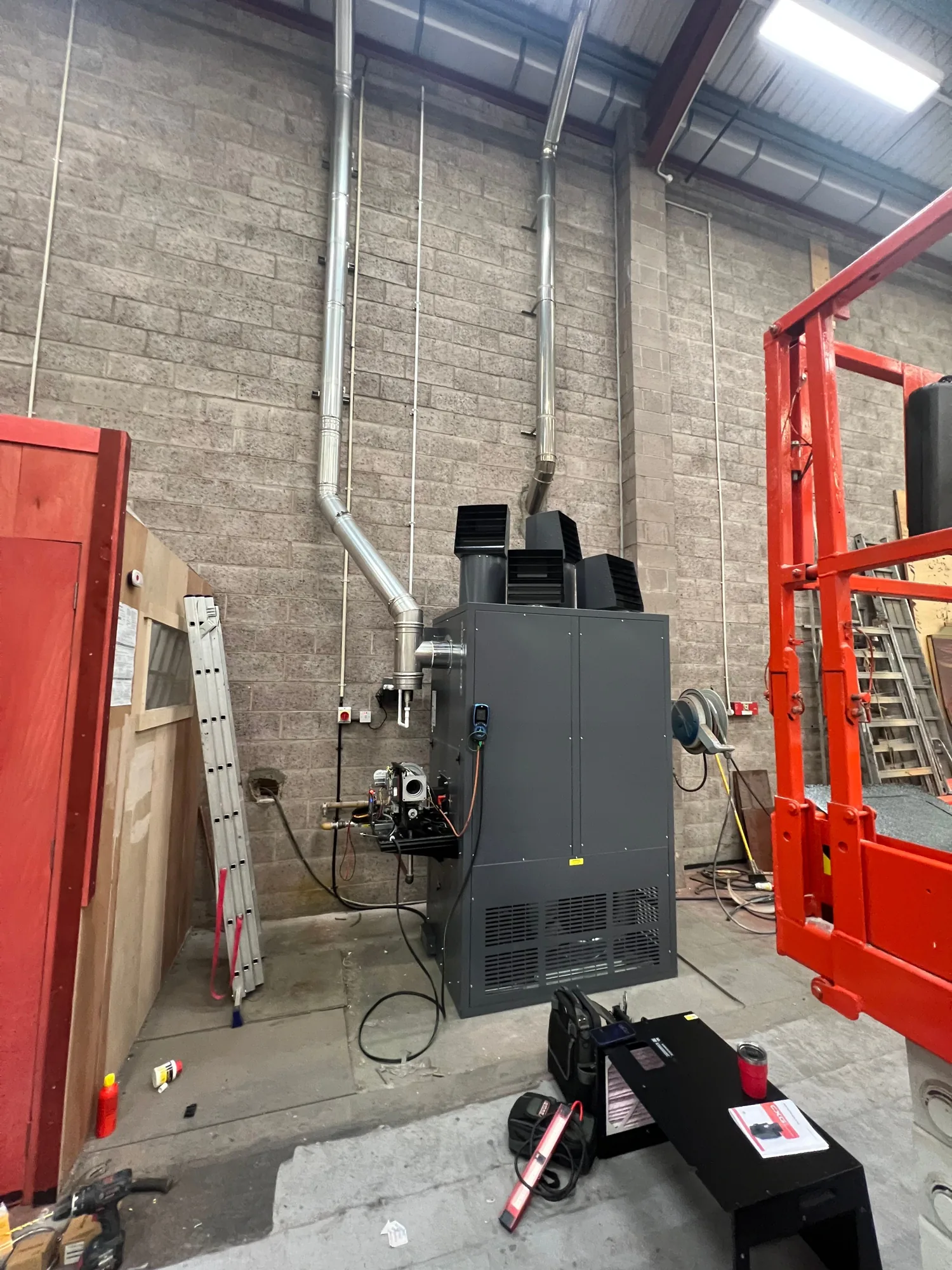 The new Powrmatic cabinet heater and burner being installed