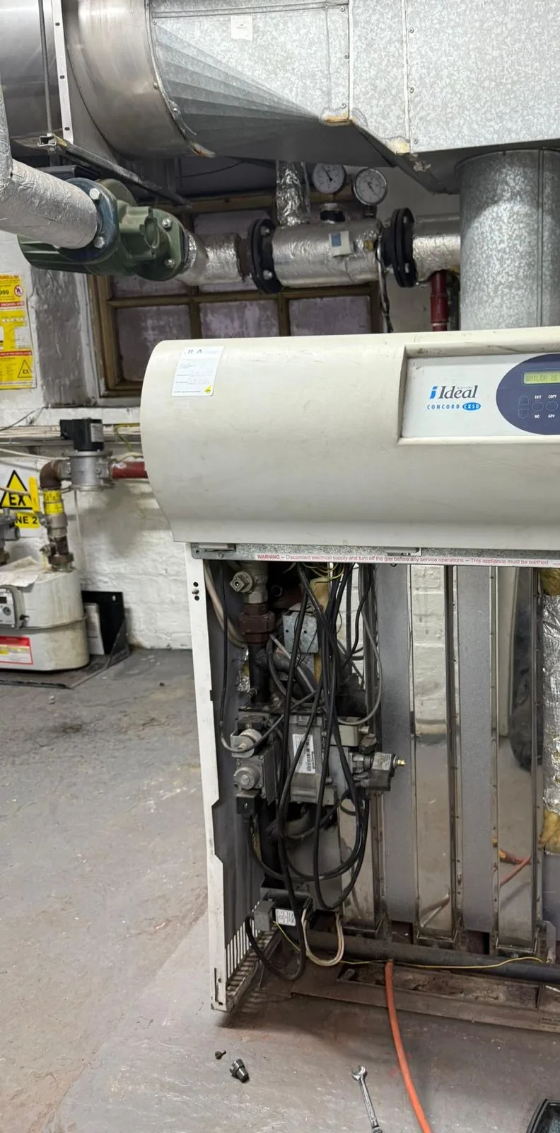 Floor-standing commercial boiler serviced with the front panel removed