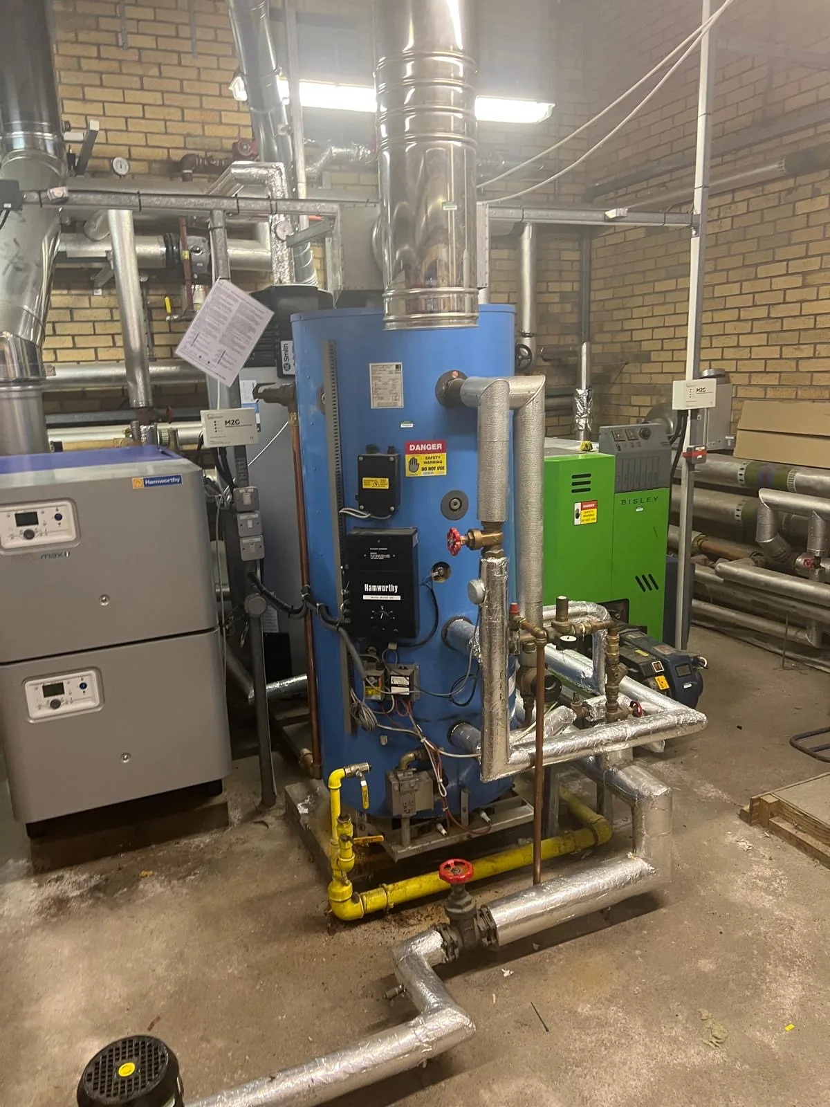 Commercial plant room with boilers, water heater and gas pipework